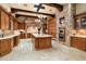 Gourmet kitchen with large island, custom cabinets, brick accents, and stainless steel appliances at 6402 E Chaparral Rd, Paradise Valley, AZ 85253