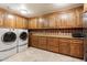 Spacious laundry room with ample storage cabinets and modern washer and dryer units at 6402 E Chaparral Rd, Paradise Valley, AZ 85253