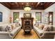 Sophisticated living room features a fireplace, wood trim, and matching sofas at 6402 E Chaparral Rd, Paradise Valley, AZ 85253