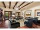 Spacious living room with wood beamed ceiling, hardwood floors, and comfortable seating at 6402 E Chaparral Rd, Paradise Valley, AZ 85253