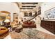 Spacious living room featuring a large rug, decorative fireplace, and ample natural light at 6402 E Chaparral Rd, Paradise Valley, AZ 85253