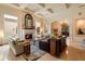 Elegant living room featuring a stone fireplace, coffered ceilings, and seamless flow to the foyer at 6402 E Chaparral Rd, Paradise Valley, AZ 85253