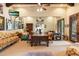 Spacious living room with eclectic decor, a large table, couches, and natural light from the windows at 6402 E Chaparral Rd, Paradise Valley, AZ 85253