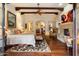 Luxurious main bedroom features beamed ceilings, a decorative fireplace, and hardwood floors for a warm ambiance at 6402 E Chaparral Rd, Paradise Valley, AZ 85253