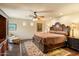 Elegant main bedroom with hardwood floors, ceiling fan, and a large, ornate bed frame at 6402 E Chaparral Rd, Paradise Valley, AZ 85253