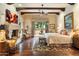 Spacious main bedroom with beamed ceilings, a cozy fireplace, and French doors leading to the outdoor courtyard at 6402 E Chaparral Rd, Paradise Valley, AZ 85253