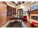 Elegant home office with custom built-ins, fireplace, wood floors and beamed ceilings at 6402 E Chaparral Rd, Paradise Valley, AZ 85253