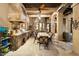 A spacious outdoor kitchen with stone finishes and a built-in grill offers an inviting space for cooking and entertaining outdoors at 6402 E Chaparral Rd, Paradise Valley, AZ 85253