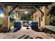 Inviting outdoor living space with a stone fireplace, ample seating, and exposed wooden beams in the covered area at 6402 E Chaparral Rd, Paradise Valley, AZ 85253
