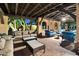 Cozy outdoor living space with comfortable seating, brick flooring, and a fireplace, perfect for relaxing or entertaining at 6402 E Chaparral Rd, Paradise Valley, AZ 85253