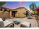 Inviting outdoor patio features comfortable seating, a glass coffee table, and dining area at 6402 E Chaparral Rd, Paradise Valley, AZ 85253