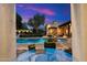 Backyard area featuring a pool, multiple seating areas, and lush landscaping for relaxation and entertaining at 6402 E Chaparral Rd, Paradise Valley, AZ 85253