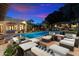 Spacious backyard featuring a large pool, multiple seating areas, and manicured landscaping for outdoor enjoyment at 6402 E Chaparral Rd, Paradise Valley, AZ 85253