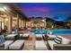 Inviting backyard featuring a pool, lounge seating, and elegant landscaping, perfect for outdoor entertainment at 6402 E Chaparral Rd, Paradise Valley, AZ 85253