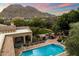Beautiful outdoor space with pool, lush landscaping, mountain views and expansive lawn at 6402 E Chaparral Rd, Paradise Valley, AZ 85253