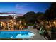 Tranquil pool featuring elegant lounge chairs, lush greenery, and stunning mountain views for a serene outdoor experience at 6402 E Chaparral Rd, Paradise Valley, AZ 85253