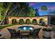 Relaxing backyard patio area featuring a stylish spa with lights, seating, and a landscaped privacy wall at 6402 E Chaparral Rd, Paradise Valley, AZ 85253