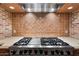 Close-up of a high-end range with stainless steel accents and decorative tile backsplash at 6402 E Chaparral Rd, Paradise Valley, AZ 85253