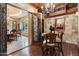 Wine room showcasing detailed ironwork, stone walls, and wine storage with access to the dining room at 6402 E Chaparral Rd, Paradise Valley, AZ 85253