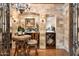 Intimate wine room with stone walls, custom shelving, and tasting area for enjoying fine wines at 6402 E Chaparral Rd, Paradise Valley, AZ 85253