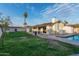 Expansive backyard featuring a refreshing pool, well-manicured lawn, and a charming patio area, perfect for outdoor living at 6718 N 19Th Pl, Phoenix, AZ 85016