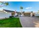 Charming single-story home with a circular driveway, palm trees and well maintained lawn at 6718 N 19Th Pl, Phoenix, AZ 85016