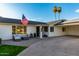 Inviting front patio with comfortable seating, lush lawn, and an American flag at 6718 N 19Th Pl, Phoenix, AZ 85016