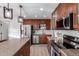 Kitchen with granite countertops, island, and stainless-steel appliances at 6718 N 19Th Pl, Phoenix, AZ 85016