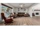 Spacious living room featuring a large sectional sofa, wood burning fireplace and hardwood floors at 6718 N 19Th Pl, Phoenix, AZ 85016