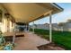 Covered patio with outdoor seating area, a grass yard, lush landscaping, and house exterior at 6718 N 19Th Pl, Phoenix, AZ 85016