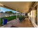 Covered patio with an outdoor dining set, manicured landscaping, grass yard, and home's exterior at 6718 N 19Th Pl, Phoenix, AZ 85016