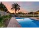 Backyard pool featuring a palm tree, pavers, lounge chairs, and manicured landscaping at 6718 N 19Th Pl, Phoenix, AZ 85016