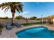 Backyard swimming pool with lounge chairs, an umbrella, a grass area, and a home's exterior at 6718 N 19Th Pl, Phoenix, AZ 85016