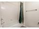 This bathroom features a tub with white tile surround, shower head, and a decorative shower curtain at 7401 W Arrowhead Clubhouse Dr # 1006, Glendale, AZ 85308