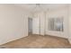 Bright bedroom offering neutral walls and carpet, a window, and a connecting door to the next room at 7401 W Arrowhead Clubhouse Dr # 1006, Glendale, AZ 85308