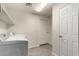 The laundry room features white appliances, tile floors, overhead lighting, and built in shelves at 7401 W Arrowhead Clubhouse Dr # 1006, Glendale, AZ 85308