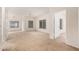 Spacious living room with neutral walls, plush carpeting, and multiple windows at 7401 W Arrowhead Clubhouse Dr # 1006, Glendale, AZ 85308