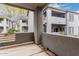 The patio features gray concrete walls with views of the neighborhood and building at 7401 W Arrowhead Clubhouse Dr # 1006, Glendale, AZ 85308