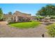 Inviting backyard with lush lawn, covered patio, sparkling pool, and scenic landscaping at 902 W Moon Valley Dr, Phoenix, AZ 85023