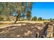 Scenic backyard view overlooking lush green golf course, trees, and blue skies in a gated community at 902 W Moon Valley Dr, Phoenix, AZ 85023