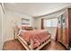 Cozy bedroom featuring wood floors, stylish furnishings, and a comfortable log-frame bed at 902 W Moon Valley Dr, Phoenix, AZ 85023