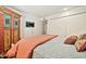 Bedroom with gray quilt, TV, and closet at 902 W Moon Valley Dr, Phoenix, AZ 85023