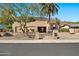 Attractive desert home boasts a classic Southwestern design, mature trees, and desert landscaping under a clear blue sky at 902 W Moon Valley Dr, Phoenix, AZ 85023