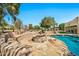 Inviting backyard with custom stone firepit, seating area, and pool, perfect for entertaining at 902 W Moon Valley Dr, Phoenix, AZ 85023