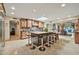 This open kitchen features a large island with bar seating, a skylight, and views into the spacious adjoining rooms at 902 W Moon Valley Dr, Phoenix, AZ 85023