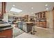 An inviting, open kitchen features a skylight, center island, and stainless steel appliances, great for culinary enthusiasts at 902 W Moon Valley Dr, Phoenix, AZ 85023