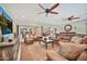 This expansive living room boasts dual ceiling fans and extends into the dining room, offering ample seating with plush couches at 902 W Moon Valley Dr, Phoenix, AZ 85023