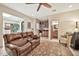 Cozy living room with a plush leather sofa, wet bar, and adjacent half bathroom at 902 W Moon Valley Dr, Phoenix, AZ 85023