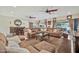 The spacious living room features cozy couches, a stylish ceiling fan, and sliding glass doors to let in plenty of light at 902 W Moon Valley Dr, Phoenix, AZ 85023
