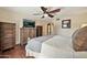Cozy bedroom featuring hardwood floors, soft lighting, and closet and ensuite access at 902 W Moon Valley Dr, Phoenix, AZ 85023